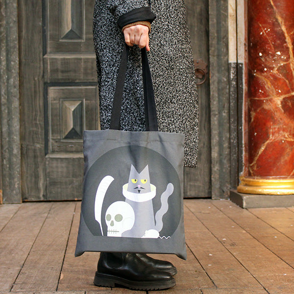 Grey cotton tote bag with two black cotton handles and black circular graphic on the centre front and back with Shakespeares cat