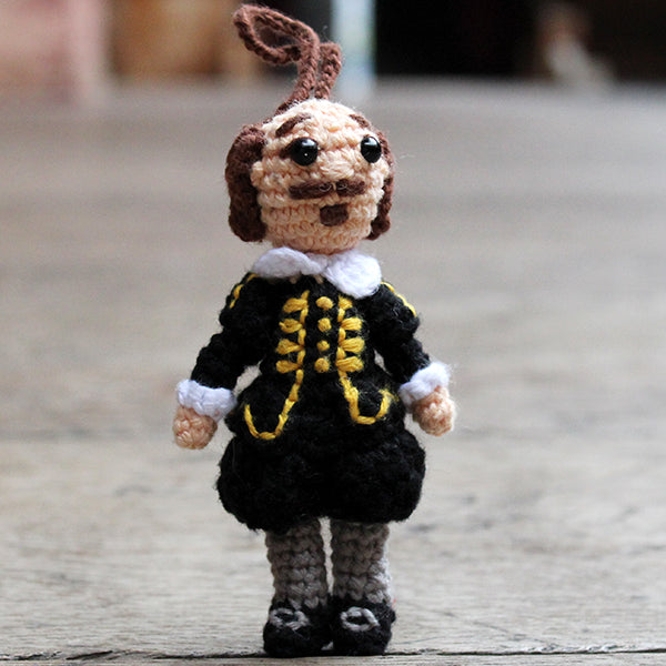 Crocheted Shakespeare decoration wearing a black doublet and hose with grey stockings