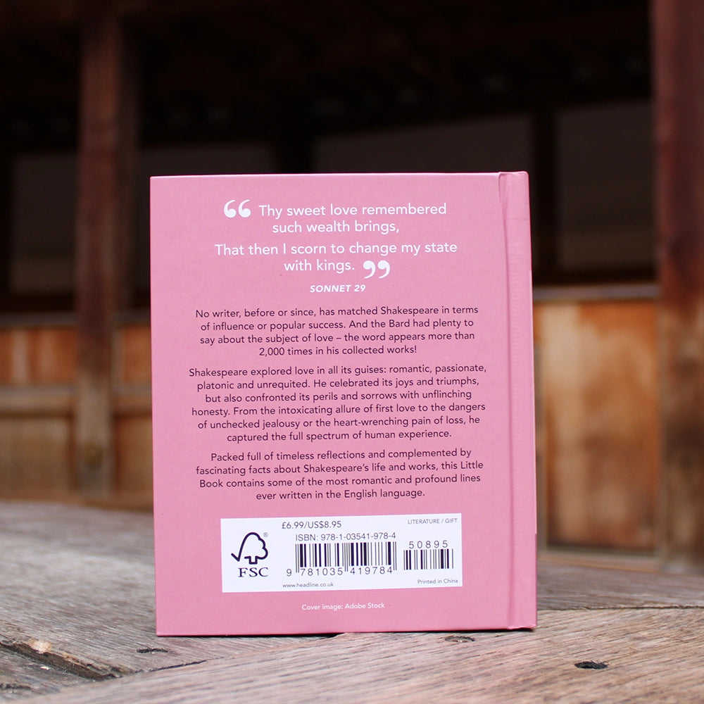 Pink hardback book with white text, red heart, and black text