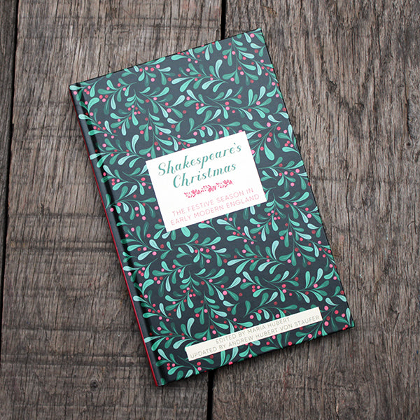 Book with green leaf pattern on a wooden surface