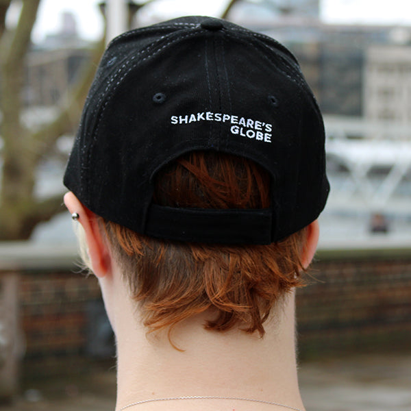 Black baseball cap with an embroidered text reading Shakespeare's Globe on the back