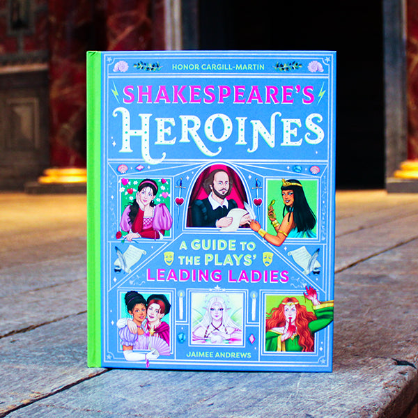 Book titled 'Shakespeare's Heroines' on a wooden surface with a blurred background