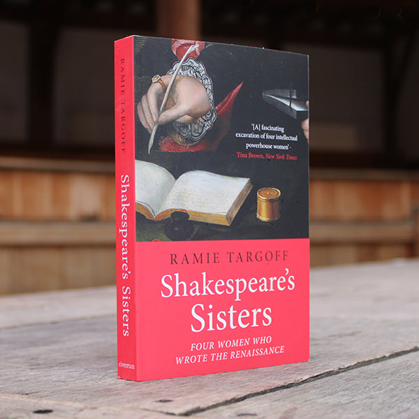 Black and red paperback book with white and black text, featuring image of writers hand with quill and ink