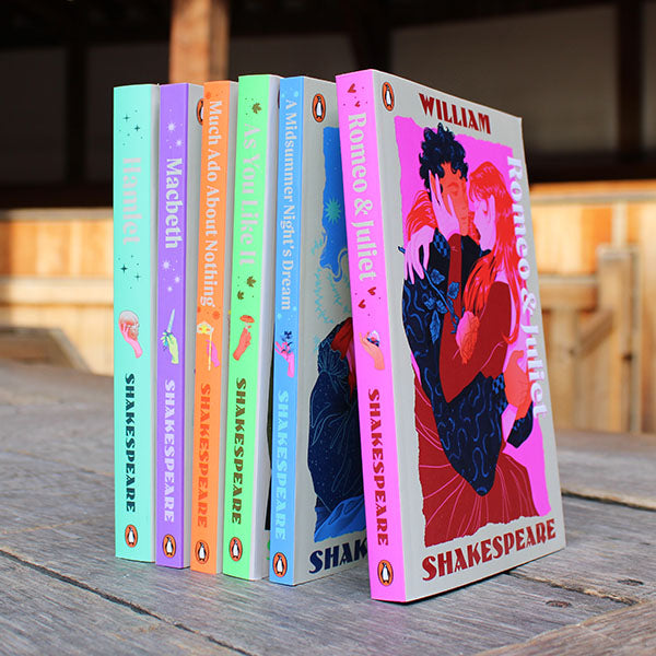 Set of Shakespeare books with colorful covers on a wooden surface