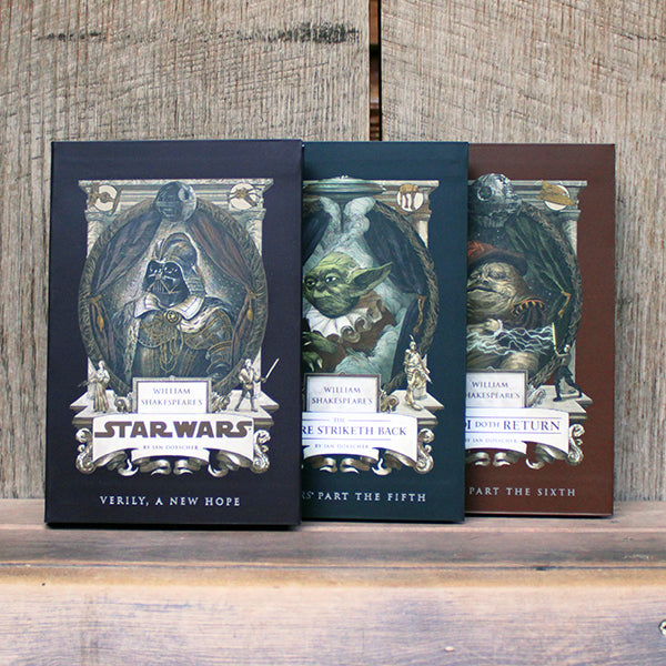 Three books with 'Star Wars' inspired covers on a wooden surface.