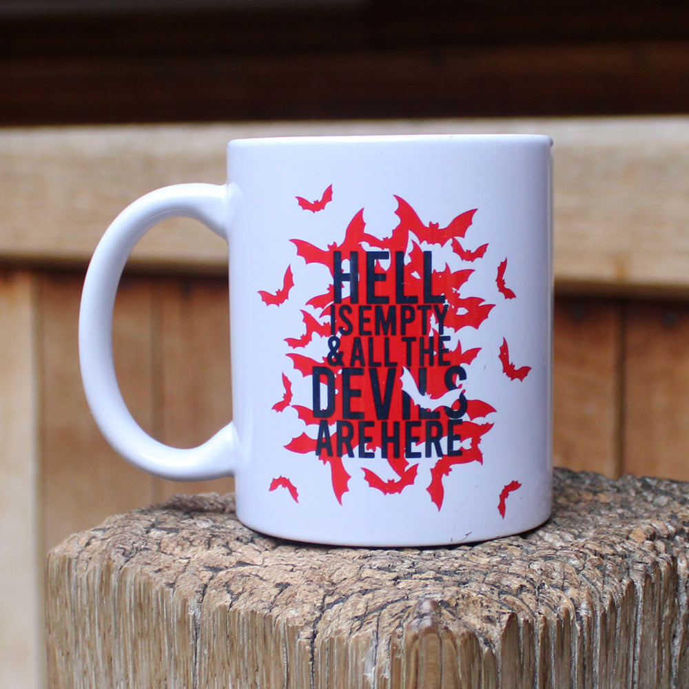White mug with red bats graphic on either side, with black text overtop