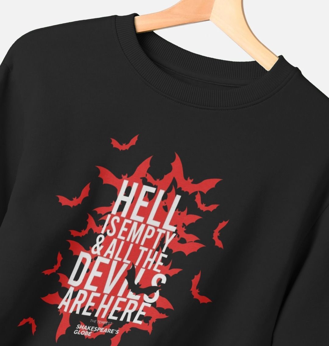 Black sweatshirt with red bat design and white text on a hanger against a light background