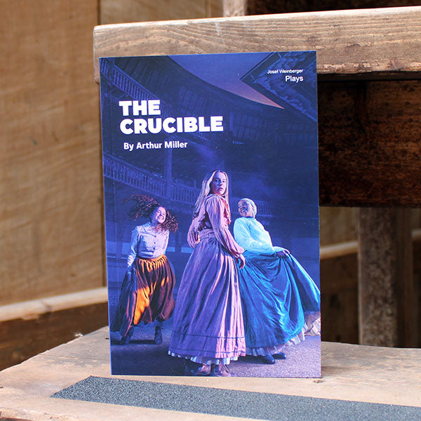 paperback back with a blue cover on a wooden step