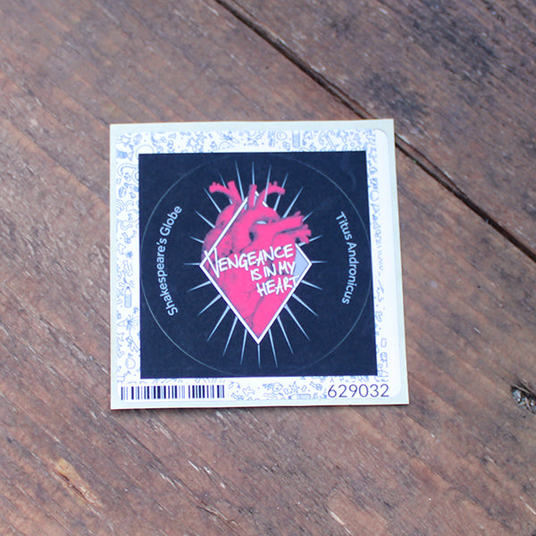 Black circular sticker with red anatomical heart graphic in the centre, with white graphic text