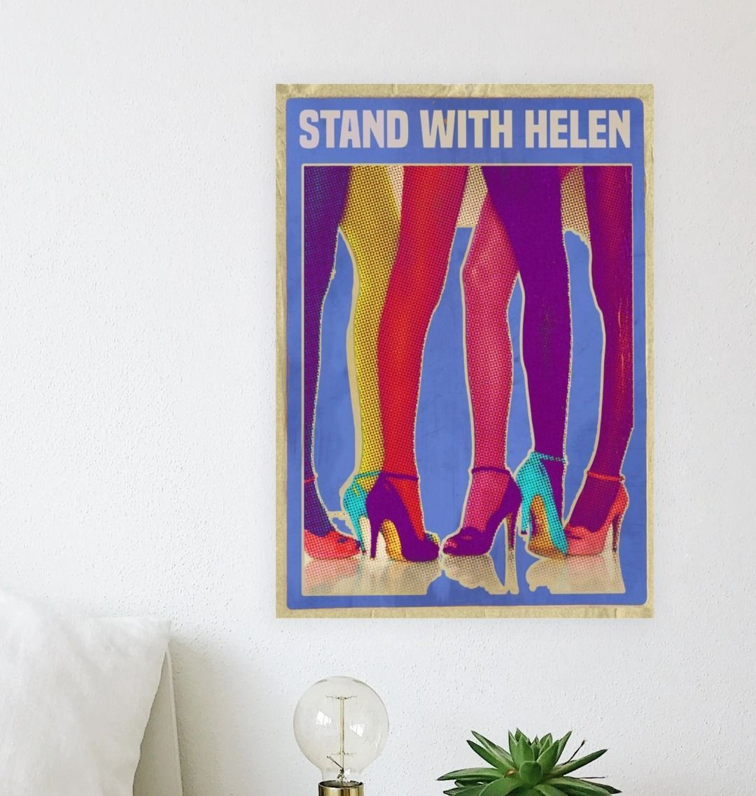Art print with colorful legs and 'Stand With Helen' text on a white wall.