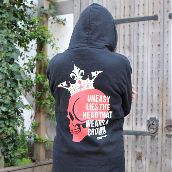 Black hoodie with red and white centred  print featuring a red skull wearing a white crown, overlayed with white text across the back