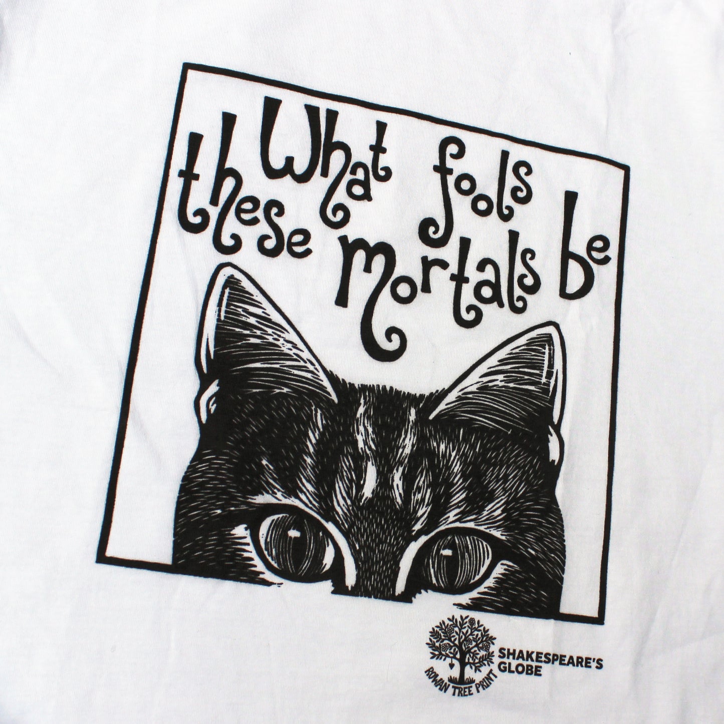 White t-shirt with black cat illustration and text 'What fools these mortals be' from Shakespeare's Globe.