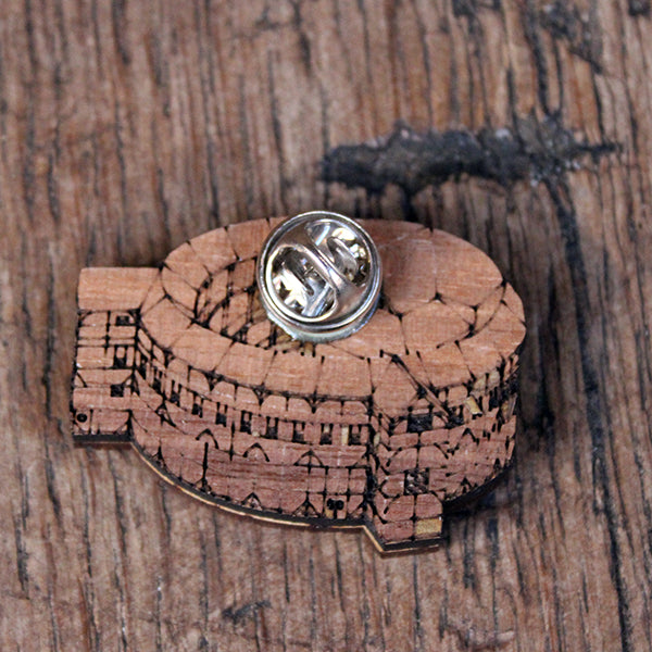 Walnut wood brooch shaped like the Globe Theatre from the back showing the fastener
