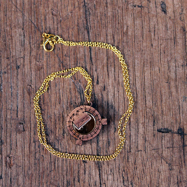 Walnut wood necklace in the shape of an architectural plan on a gold-coloured chain