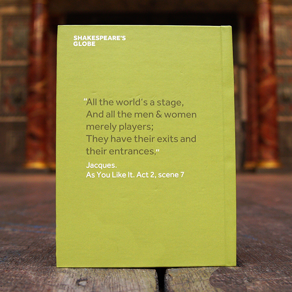 Sage green hardback journal with a quote from Shakespeare play, As You Like It (All the world's a stage) printed in white on the cover. The lettering is hand-drawn in a scribble style and has small lime green leaves growing out of it.