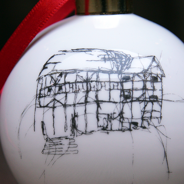 White glass bauble with black etched drawing of Shakespeare's Globe and gold top, with red tied ribbon