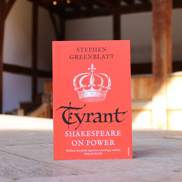 Paperback copy of 'Tyrant: Shakespeare on Power' by Stephen Greenblatt sitting on a wooden stage