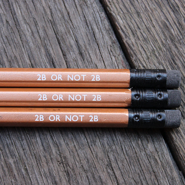 
                  
                    Gold pencil with black eraser, stamped with white: 2B OR NOT 2B
                  
                