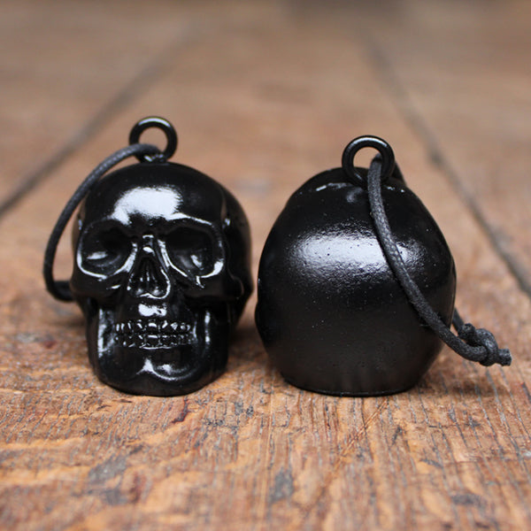 
                      
                        Black plaster skull decoration with rope tie, on wooden floor
                      
                    