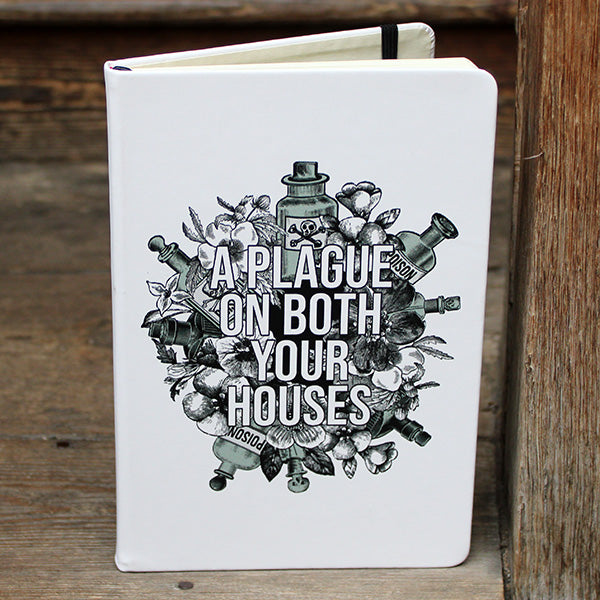 White hardback journal with a black and light green print on the cover.