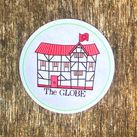 Sticker with 'The Globe' building illustration on a wooden surface