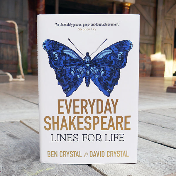 White hardback book with a paper wrapper printed with a blue butterfly and gold writing.