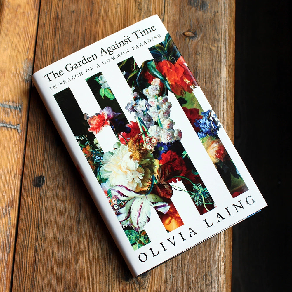 
                      
                        White hardback book with colourful illustrations of flowers on the cover
                      
                    