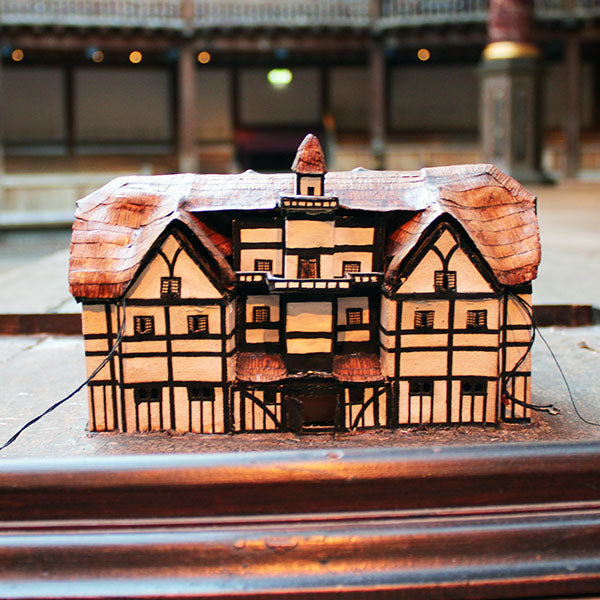 Model of a half-timbered theatre set against a stage background.