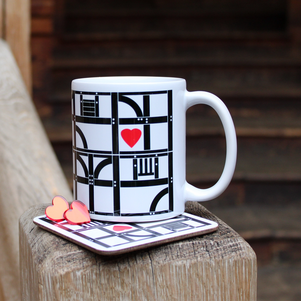 Closeup image of red, white and black Globe Theatre shop range on natural background