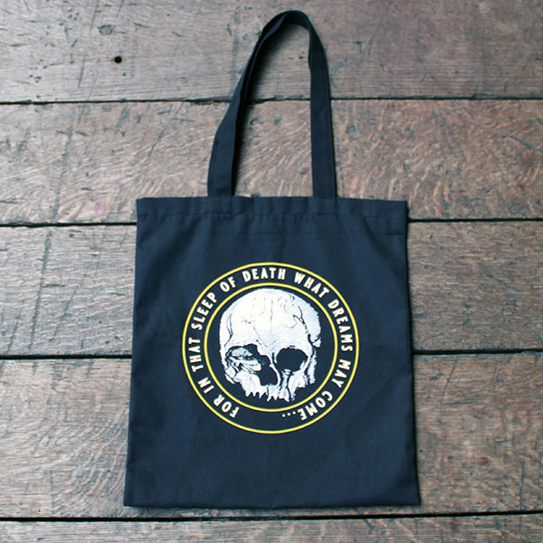 
                      
                        Black cotton two handle tote bag with circular graphic of skull with surrounding text
                      
                    