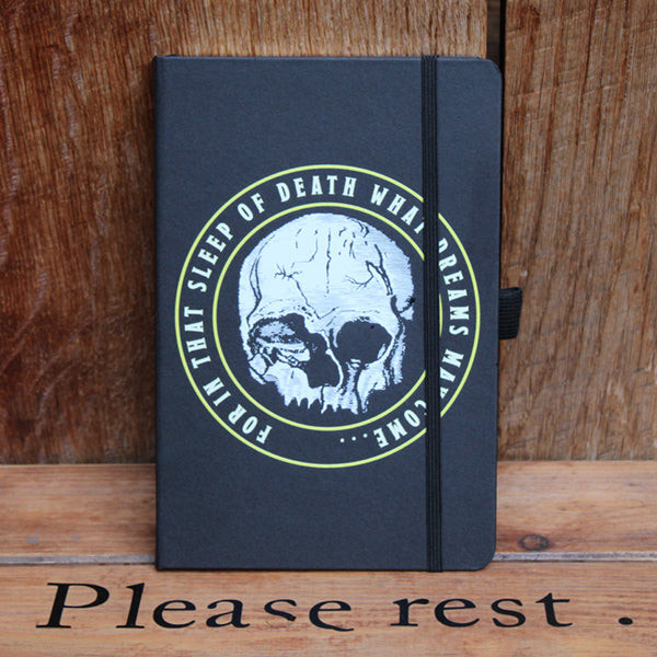 Black matt portrait orientated hardback journal with centre white skull graphic and surrounding text