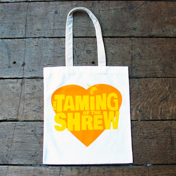 White cotton bag with a bright yellow and orange typographic print