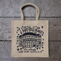 Jute two handle tote bag with black graphic text and drawing of Shakespeare's Globe printed on it