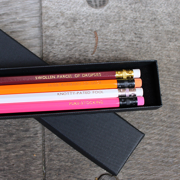 Four brightly coloured pencils with erasers in a black gift box