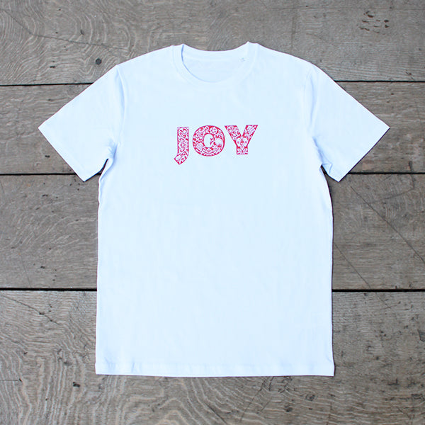 white t-shirt with a red patterned text print on the chest that reads JOY