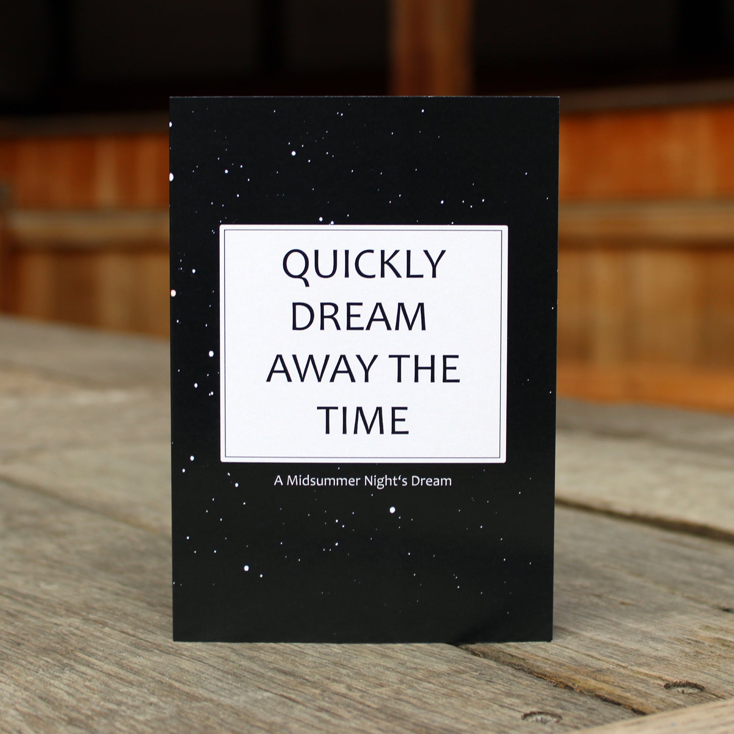 Black greetings card with a galaxy print and a quote in a white box