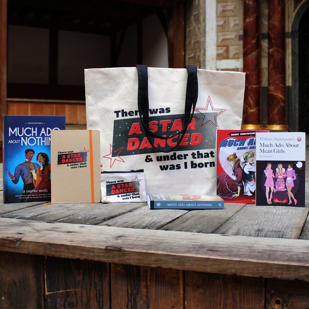 Much Ado About Nothing gift range sitting on wood panel Globe stage, from left to right, paperback play text, paperback graphic novel, hardback journal, canvas tote bag, cotton purse, paperback manga, paperback book