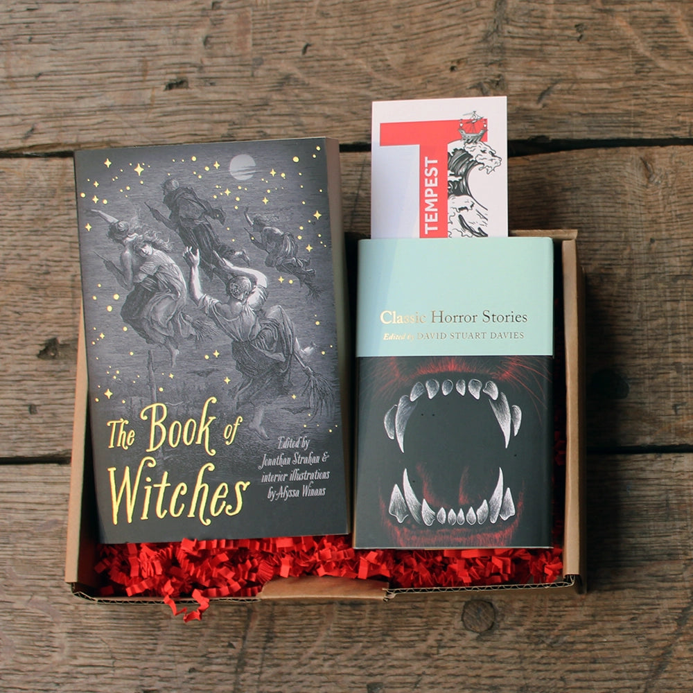 October book box with 1 black paperback book, 1 teal and black hardback book and 1 white and red paper bookmark