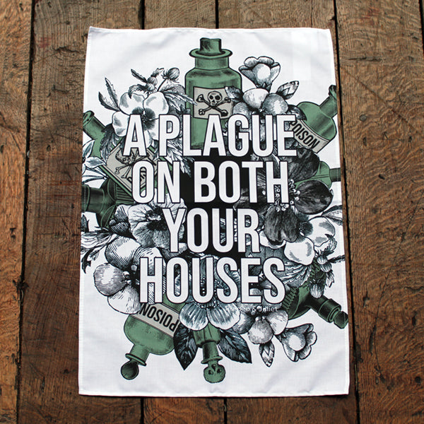 White kitchen towel printed with a design of flowers and green poison bottles