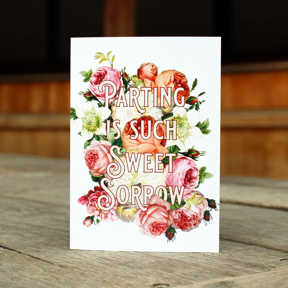 white greetings card with a floral pattern and a quote in large letters over the top.