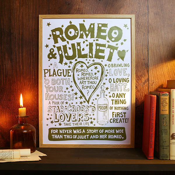 Framed print of 'Romeo & Juliet' text on a wooden shelf with books and a candle.