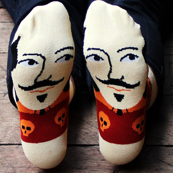 
                  
                    Two feet with Shakespeare face socks, showing bottom of the sock
                  
                