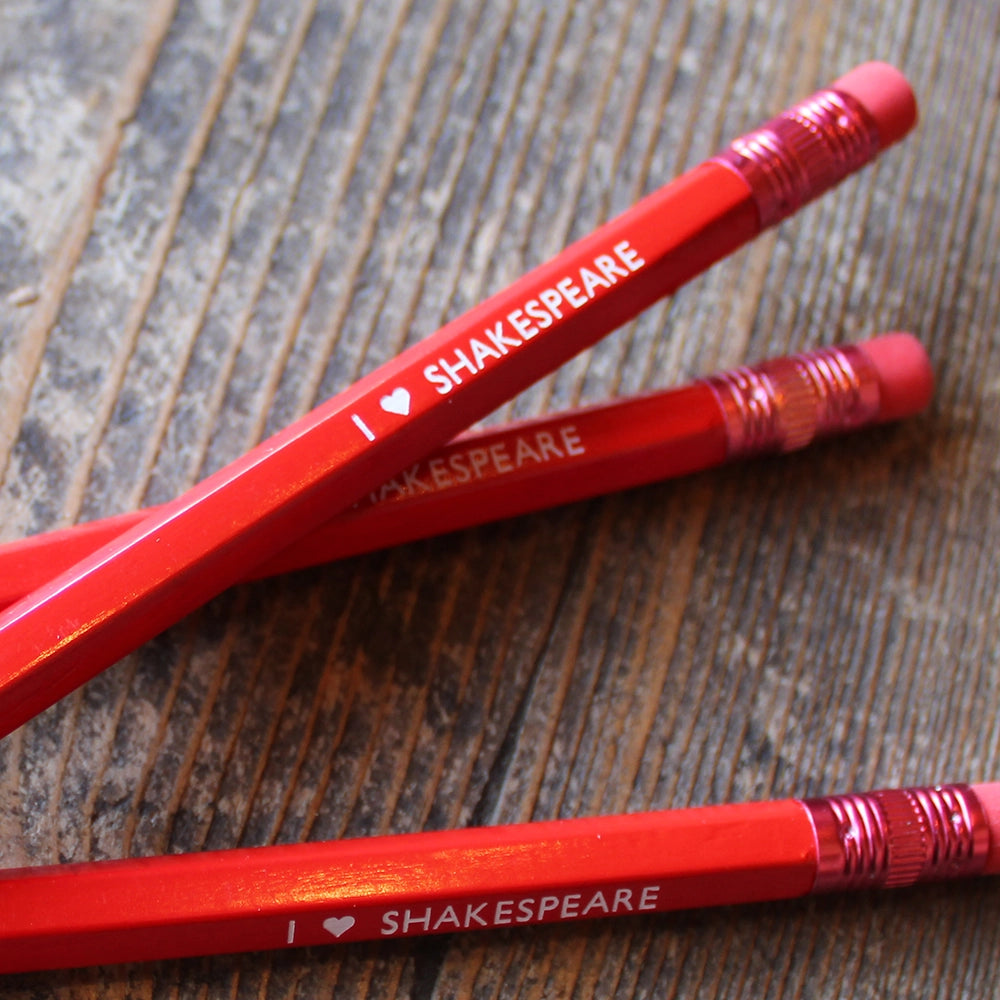 
                  
                    Red pencil with red eraser and white stamped text
                  
                