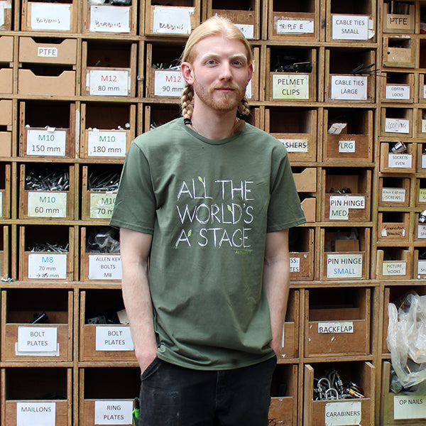 Sage green t-shirt with a round neckline. The t-shirt has a quote from Shakespeare play, As You Like It (all the world's a stage) printed in white centrally on the chest.
