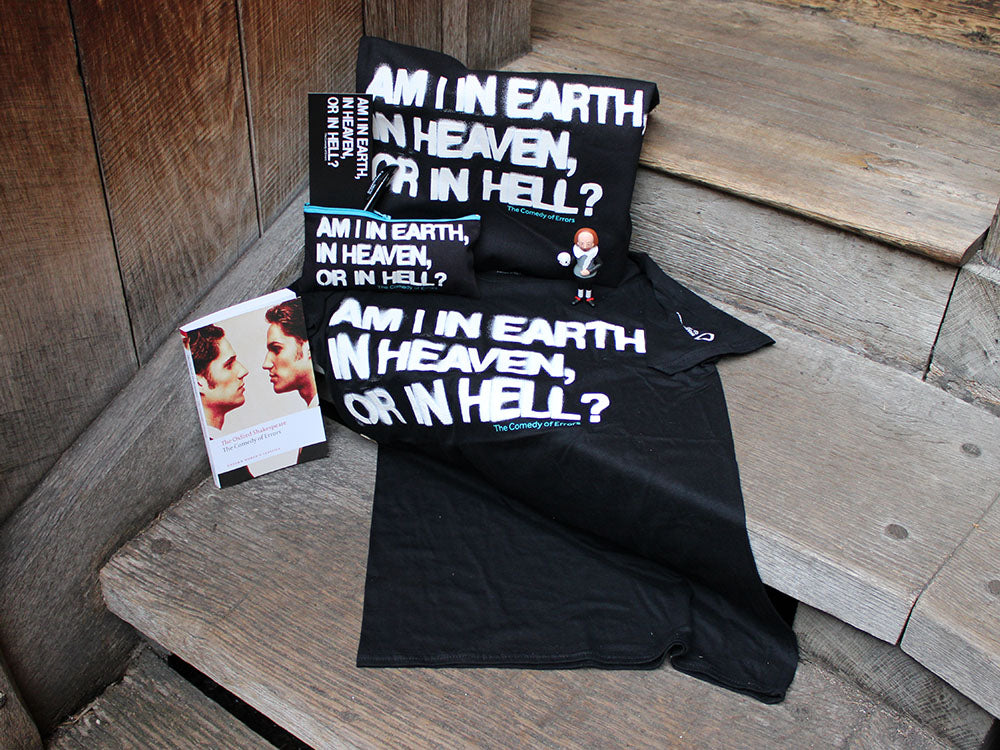 Black t-shirt, tote bag and pencil case with stylised white graphic text sitting next to white paperback book with identical twins on the cover