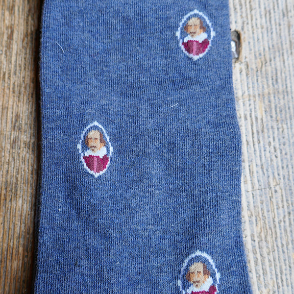 
                  
                    Mid blue socks with a repeating pattern of a portrait of William Shakespeare in a white oval.
                  
                