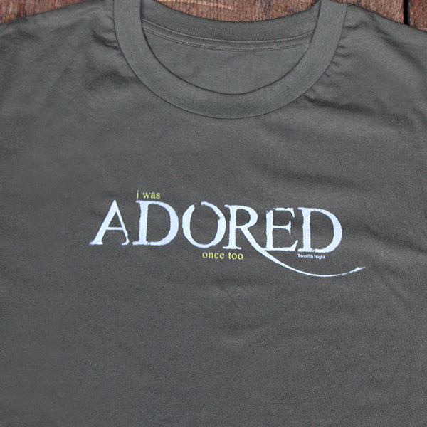 
                  
                    Sage green t-shirt with stylised white graphic text
                  
                