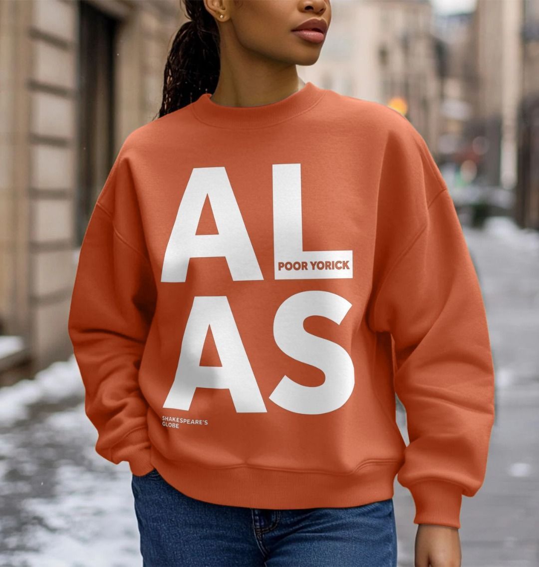 White oversized block text spelling A L about A S on an oversized orange sweatshirt