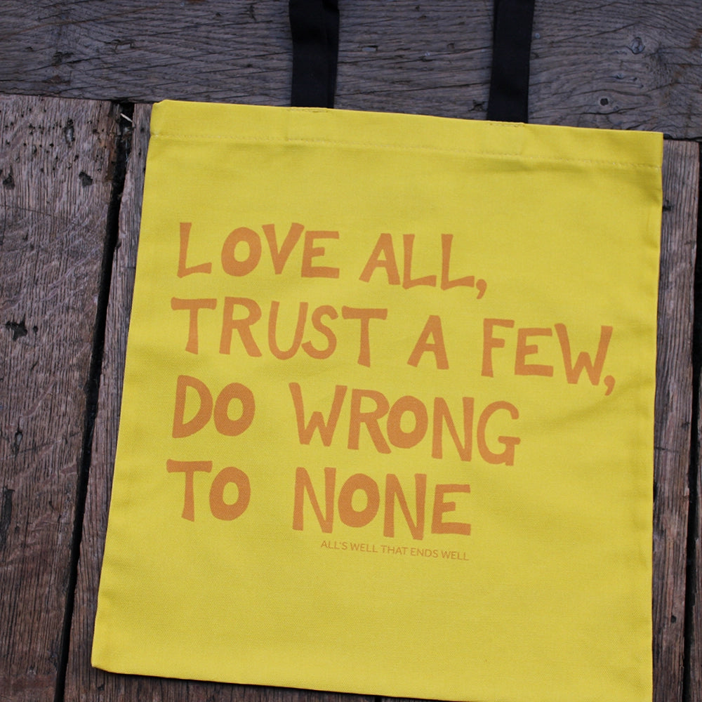 
                      
                        Yellow tote bag with scratchy gold writing and black handles
                      
                    