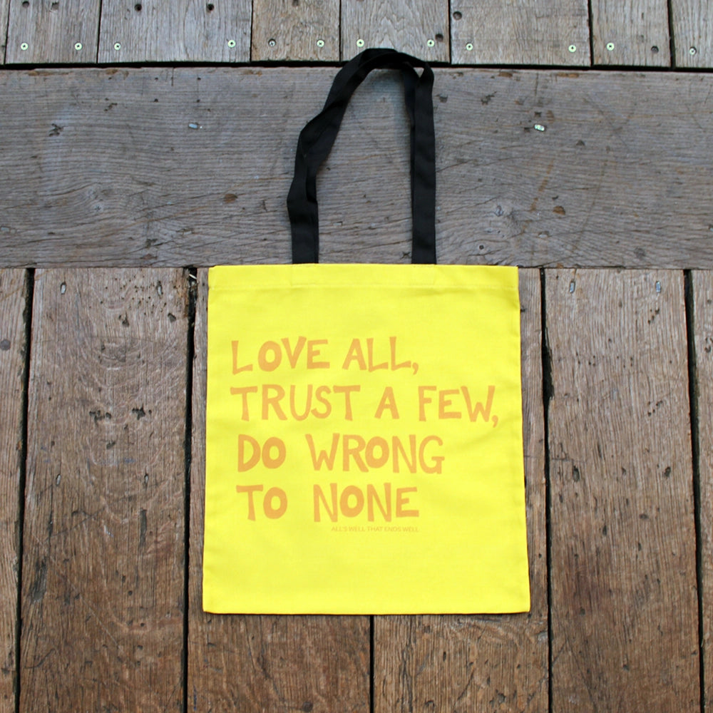 
                      
                        Yellow tote bag with scratchy gold writing and black handles
                      
                    